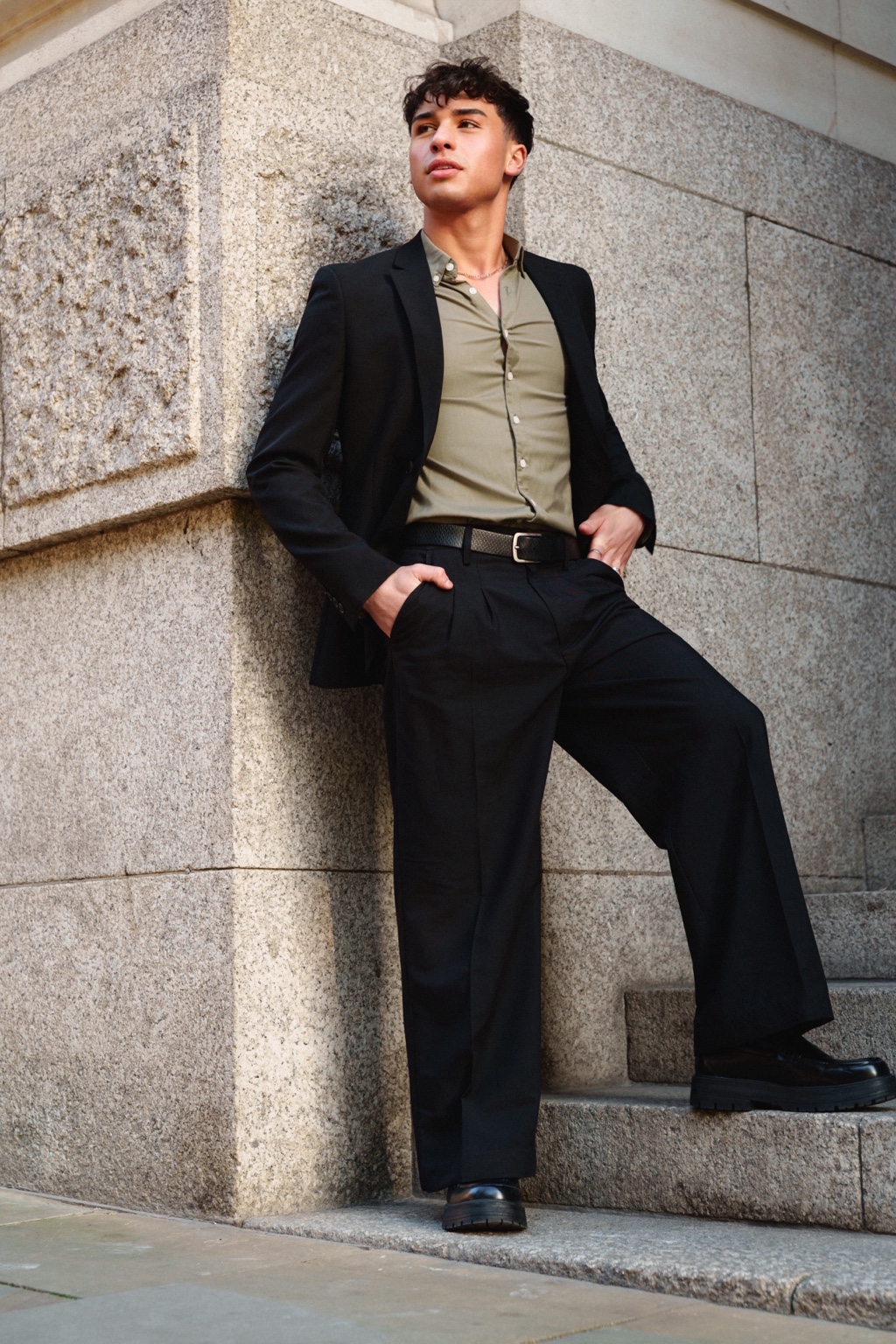Bobs standing in a black suit